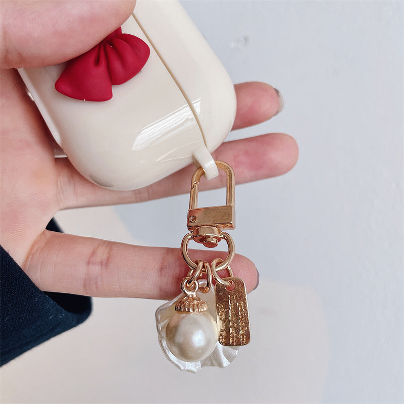 Beige Wireless Earphone Case with Red Bow & Shell Pendant – Cute Protective Cover